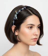 Load image into Gallery viewer, girl wearing a decorative headband with silver cat figurine and beads on a white background
