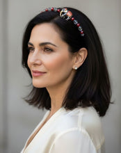 Load image into Gallery viewer, Woman wearing a flexible headband featuring an enameled elephant centerpiece with red and silver colors, accented with sparkly Austrian crystal beads, primarily in red and silver tones.